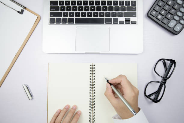 istock Top View Office Desktop With Hands Of Businessman 1069003460