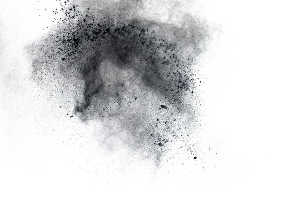 istock Black powder explosion. The particles of charcoal splatter on white background. Closeup of black dust particles splash isolated on  background. 1069006848