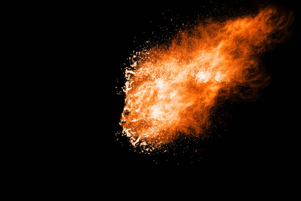 istock orange dust particles explosion on black background. Color powder dust splash. 1069006874