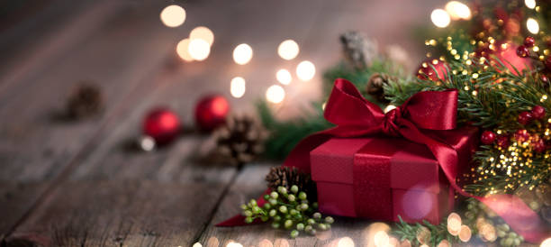 istock Christmas garland wreath with gift on old wood background 1069013434