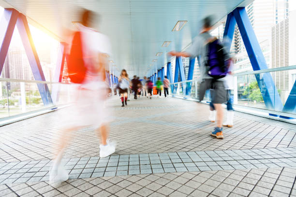 istock Group of people walking on city footbridge 1069018166