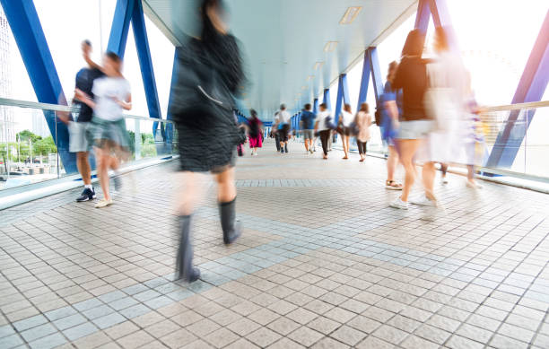 istock Group of people walking on city footbridge 1069018192