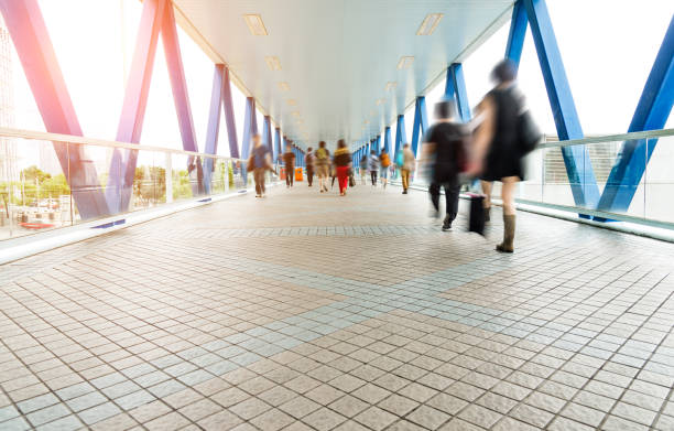 istock Group of people walking on city footbridge 1069019228