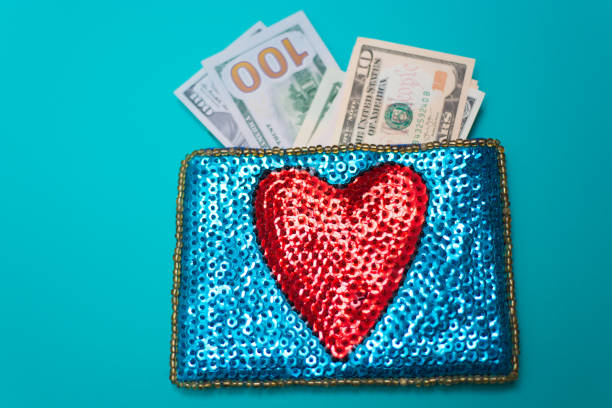 istock Dollar Bills in Glittery Change Purse with Heart 1069021086