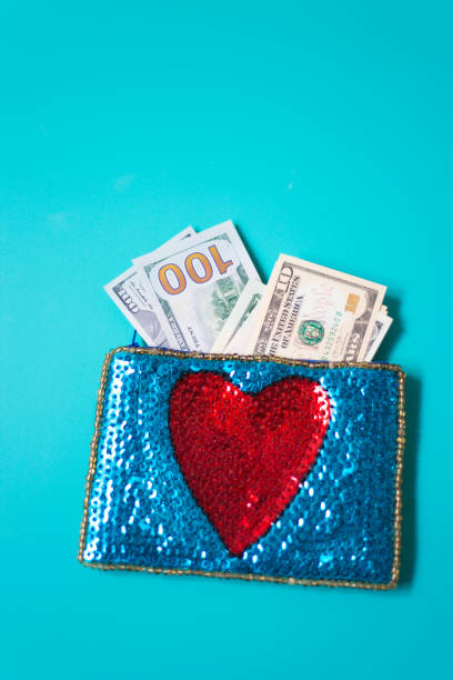 istock Dollar Bills in Glittery Change Purse with Heart 1069021118