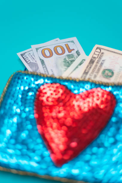 istock Dollar Bills in Glittery Change Purse with Heart 1069021136