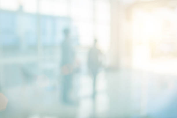 istock Businessmen blur in the workplace or work space of table in office room with computer or shallow depth of focus of abstract background. Business blur interior in hospital have modern commercial hall. 1069023562