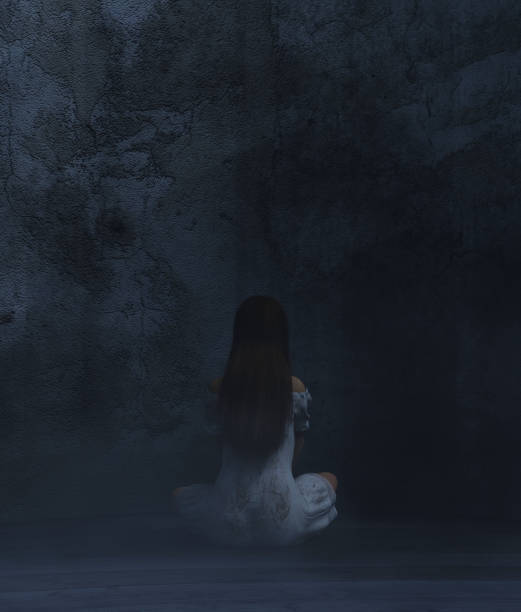 istock Woman sitting in a dark room 1069026486