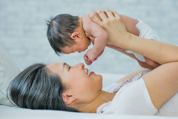 istock Mom playing with infant son 1069028858