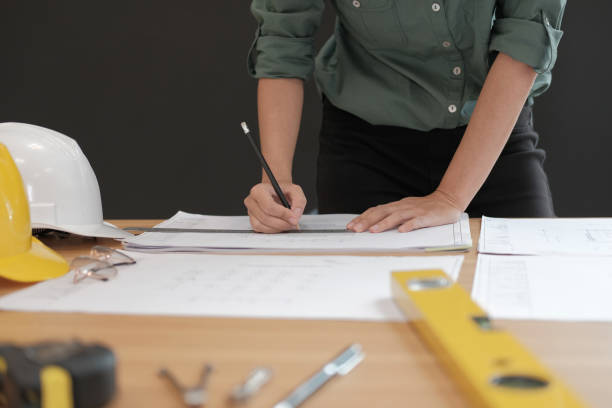 istock architect engineer working on house blueprint of real estate project at workplace. building construction concept 1069030874