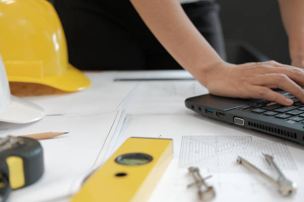 istock architect engineer working on house blueprint of real estate project at workplace. building construction concept 1069030932