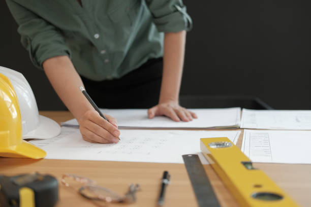 istock architect engineer working on house blueprint of real estate project at workplace. building construction concept 1069031034