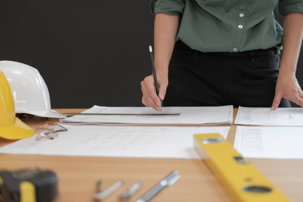 istock architect engineer working on house blueprint of real estate project at workplace. building construction concept 1069031082