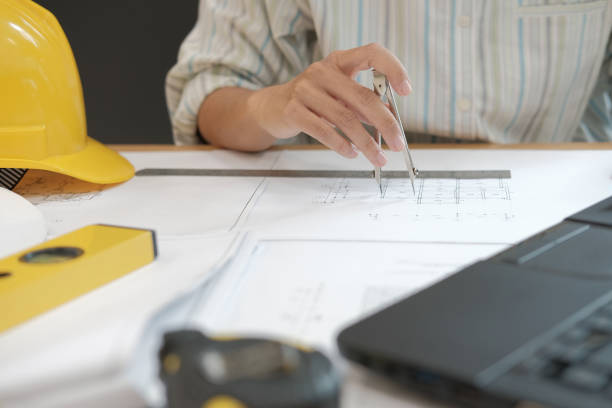 istock architect engineer working on house blueprint of real estate project at workplace. building construction concept 1069031152