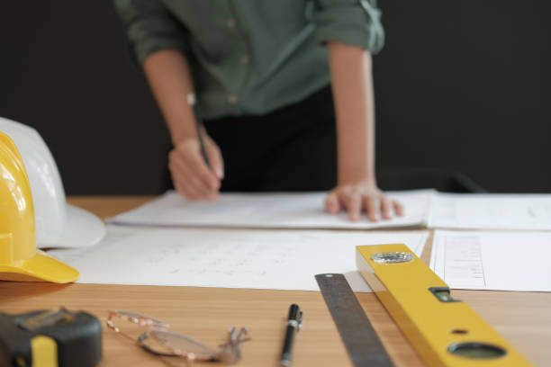 istock architect engineer working on house blueprint of real estate project at workplace. building construction concept 1069031222