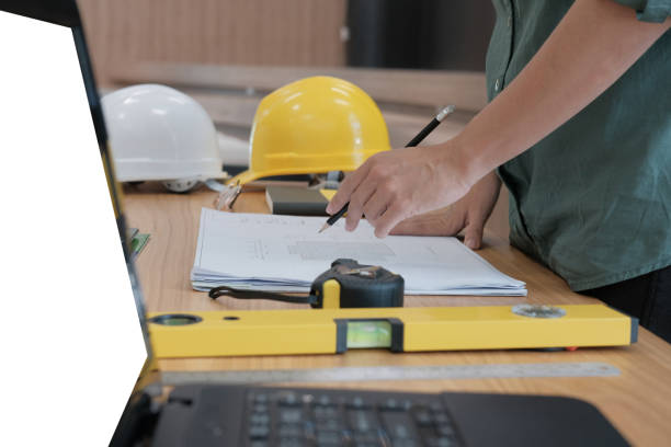 istock architect engineer working on house blueprint of real estate project at workplace. building construction concept 1069032364