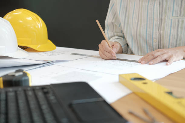 istock architect engineer working on house blueprint of real estate project at workplace. building construction concept 1069032368