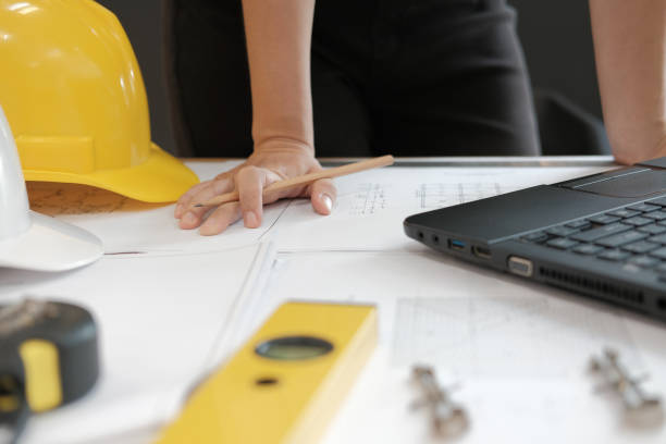 istock architect engineer working on house blueprint of real estate project at workplace. building construction concept 1069032376