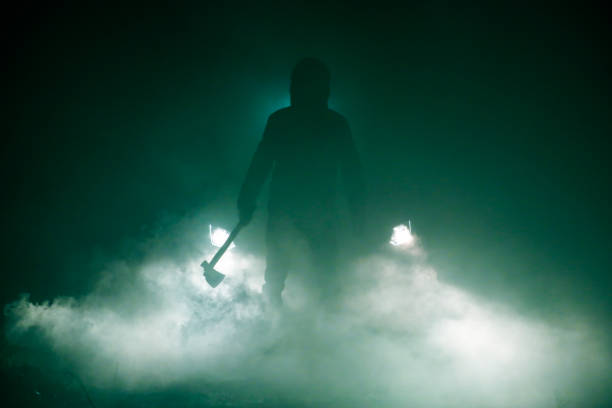 istock Man holding axe standing in front of car 1069032414