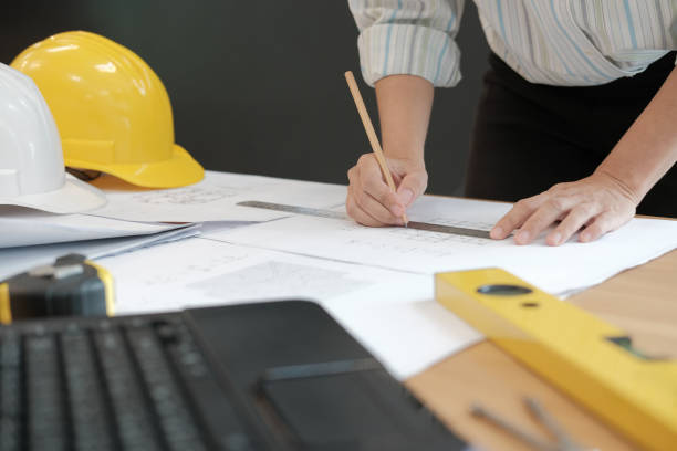 istock architect engineer working on house blueprint of real estate project at workplace. building construction concept 1069032432