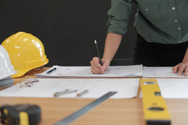 istock architect engineer working on house blueprint of real estate project at workplace. building construction concept 1069032434
