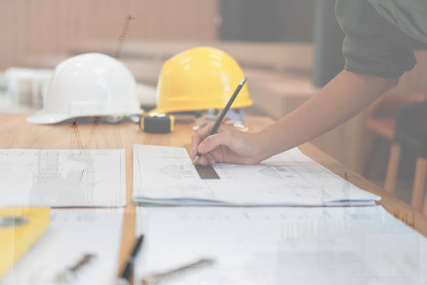 istock architect engineer working on house blueprint of real estate project at workplace. building construction concept 1069032462
