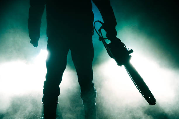 killer Holding Chainsaw killer Holding Chainsaw serial killings photos stock pictures, royalty-free photos & images