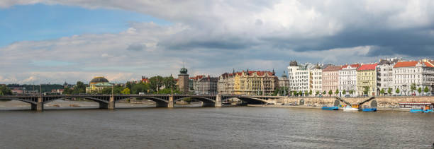 view of the Vltava Embankment and the dancing house in Prague, Czech Republic view of the Vltava Embankment and the dancing house in Prague, Czech Republic Stitched Panorama dancing house prague stock pictures, royalty-free photos & images