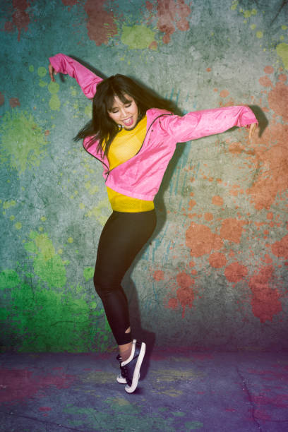 istock Happy woman doing break dance in the studio 1069042786