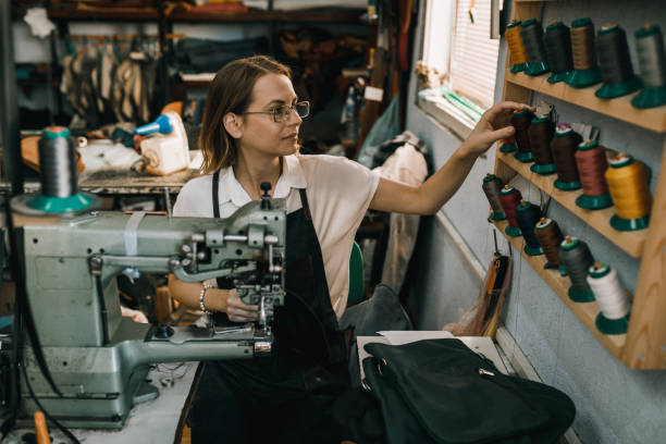 istock Woman working and sewing in the textile workshop 1069045448