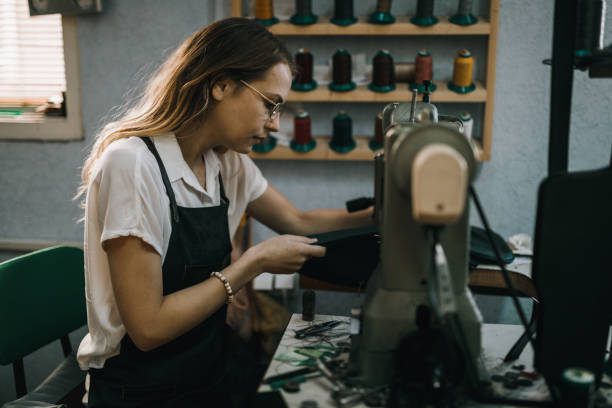 istock Portrait of a young woman working and using sewing machine 1069045472