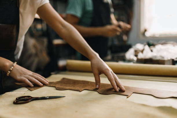 Close-up of people working in the leather workshop