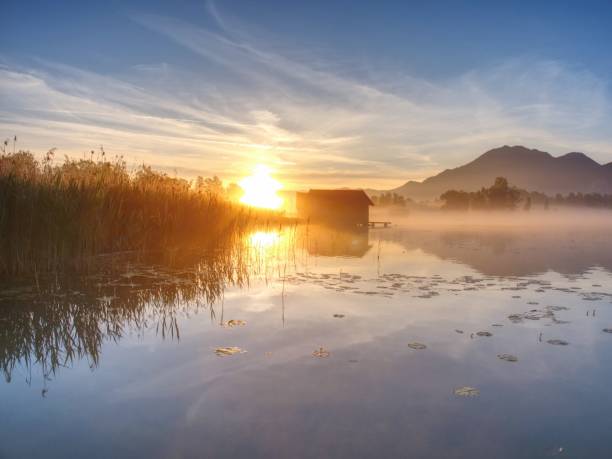 istock The mountain lake with dock and boat house 1069045630