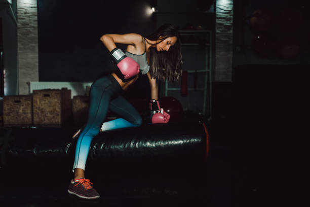 istock Young strong woman having a kickbox training in the gym 1069046840