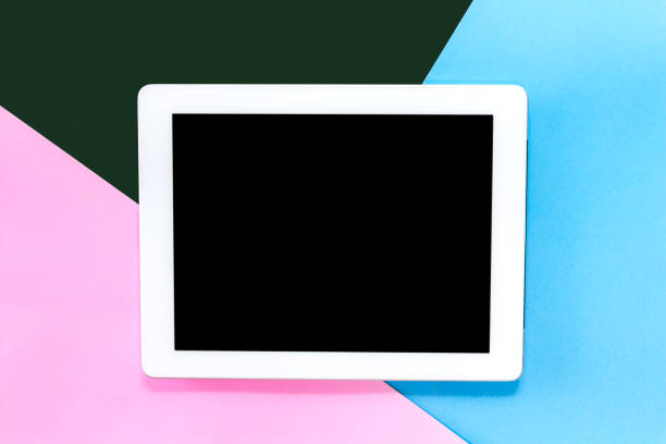 istock Top view of mockup digital tablet with blank screen on blue and pink pastel background.technology and communication concept.Flat lay 1069047038