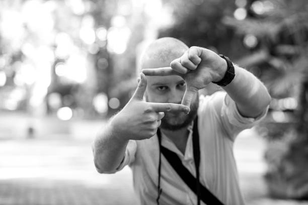 istock Young male photographer framing a shot using his fingers 1069052948