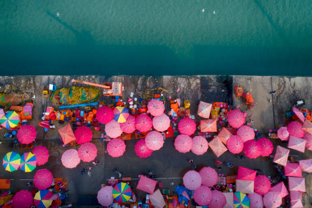 istock People and sun umbrellas on fish market. 1069060338