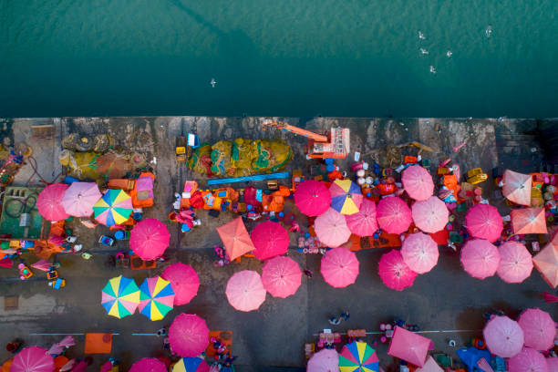 istock People and sun umbrellas on fish market. 1069060416