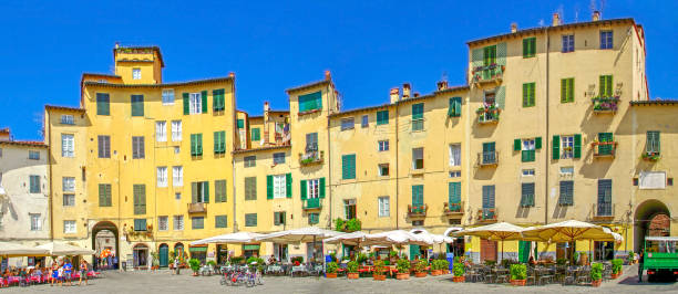 Lucca, Tuscany, Italy Piazza dell'Anfiteatro, old town square in Lucca, Tuscany, Italy lucca italy stock pictures, royalty-free photos & images
