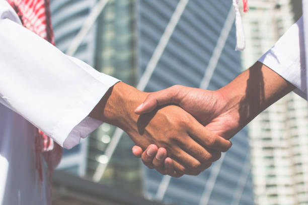 istock Two confident arab businessman shaking hands. Successful business partners. Negotiating business. The business man happy with work and enjoy with workmate. Finishing up a meeting. 1069062648