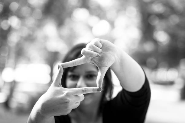 istock Young woman photographer framing a shot using her fingers 1069062926