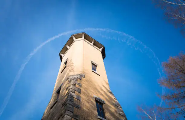 Observation tower in nature with view from below and blue sky