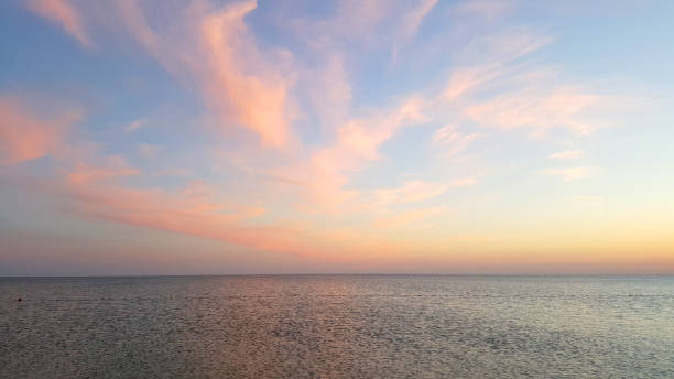 istock The sea horizon after a decline with pink clouds 1069077956