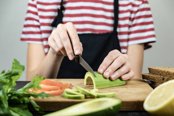 istock Slicing avocado for healthy sandwich 1069081498