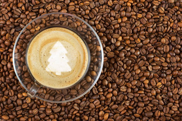 istock Cup of espresso with christmas treesign on coffee foam on coffee beans background. With copy space 1069083400