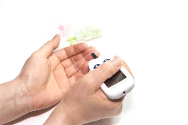 istock A scene where blood is examined on a woman's finger using a glucose meter. 1069083608
