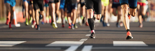istock Marathon running race, people feet on city road 1069093604