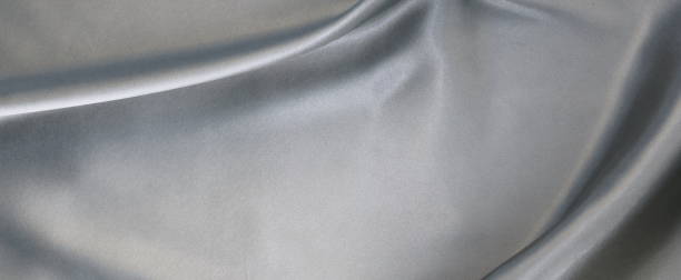 istock Fabric silk satin texture background silber color.Abstract background of luxury cloth wave. 1069096032