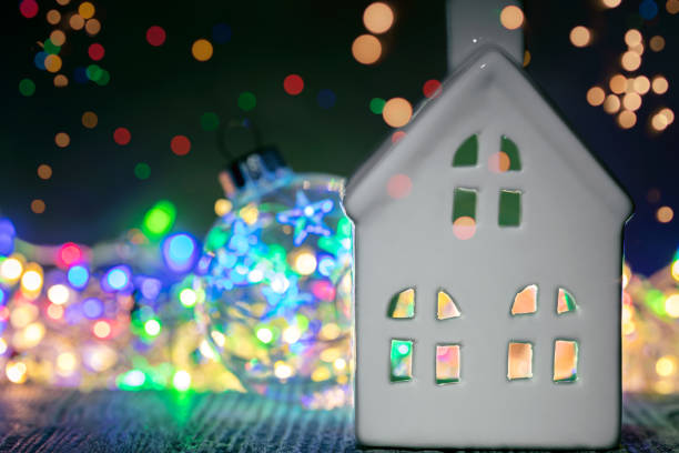 istock decorative christmas house against background with multicolored lights garland 1069099520