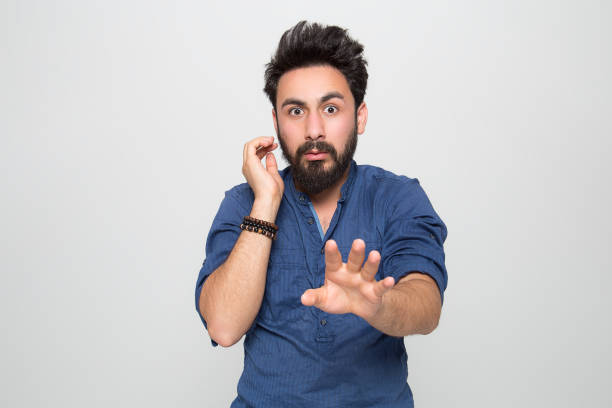 istock Portrait of shocked young man over grey background 1069099538
